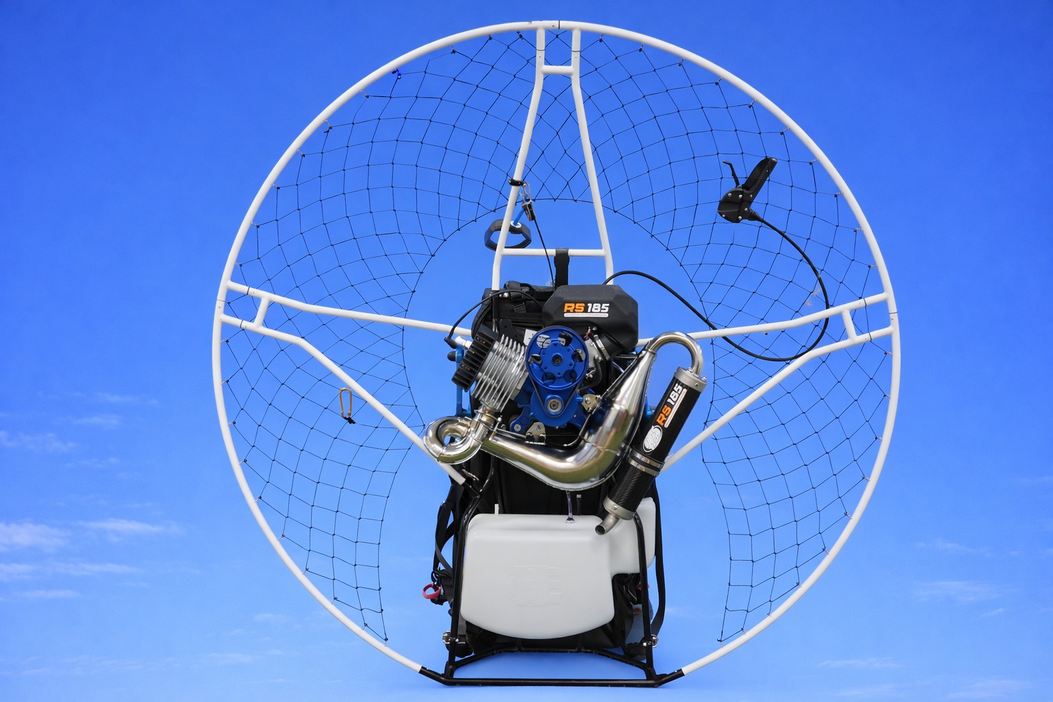 Daytona Sport Titanium RS 185cc complete paramotor with white cage and polished exhaust against blue sky
