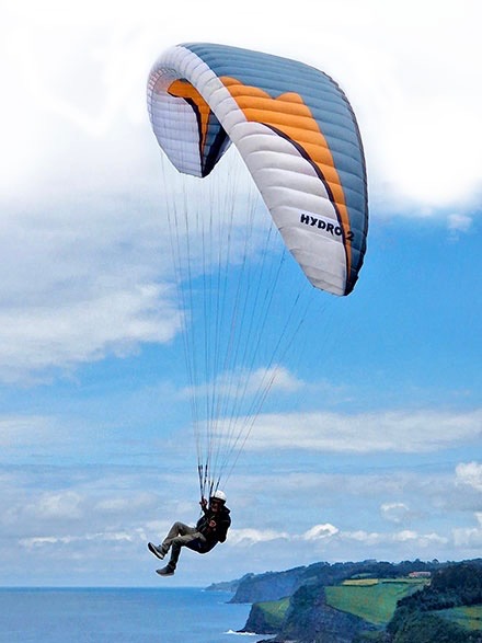 Pilot flying HE Paramotors Hydro over water